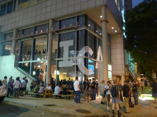 An image of The Institute of Contemporary Art at night with people outside.